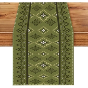 Detailed macro view of bohemian olive green table runner with ethnic geometric patterns