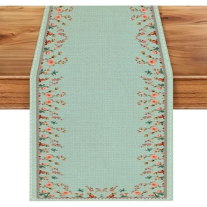 Mint green floral table runner with pink and orange flowers on a rustic wooden table