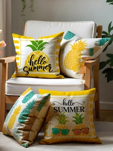 Detail view of four tropical pineapple print pillow covers on a white Nordic chair