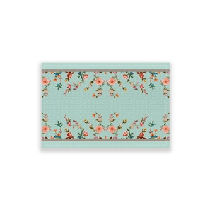 Detail of mint green floral table runner featuring pink flowers and stitched edge
