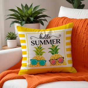 Hello Summer pineapple print cushion cover on a white sofa with orange knitted blanket