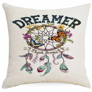 Detail of bohemian dreamcatcher cushion cover with feathers and dreamer text on linen fabric