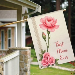Detail of Best Mom Ever garden flag with pink carnations on a rustic porch