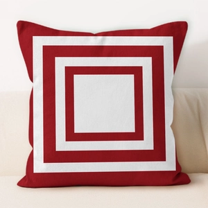 Detail of red and white square geometric patterns on a modern minimalist pillowcase