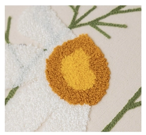 Detailed macro view of white floral towel embroidery on canvas cushion cover