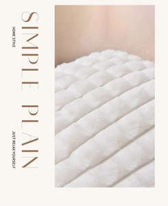 Detail of white faux rabbit fur pillow cover featuring a soft 3D puffy grid pattern texture