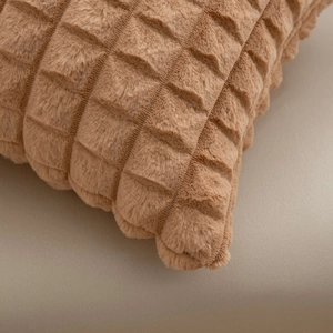 Close-up of plush camel cushion cover with decorative 3D square lattice texture