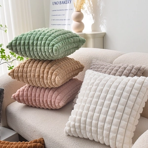 Chic checkered faux rabbit fur pillow covers in multiple colors on a soft sofa