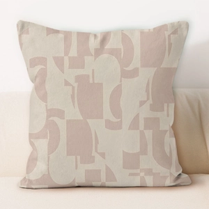 Detail of cream geometric pillow cover with abstract Morandi pink patterns on a sofa