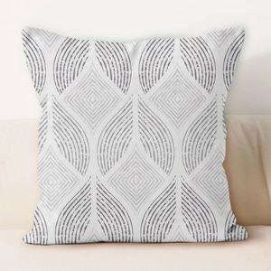 Cream geometric square throw pillow cover with abstract grey patterns on a beige sofa