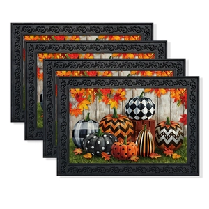 Set of four Thanksgiving place mats with autumn pumpkin designs and black embossed borders