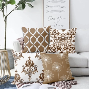 Set of four geometric throw pillow covers in brown and white on a modern sofa