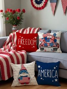 Close-up of four Independence Day pillow covers with patriotic gnomes on a grey sofa