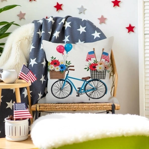 Detail of floral Independence Day pillow cover on a wicker chair with 4th July decor