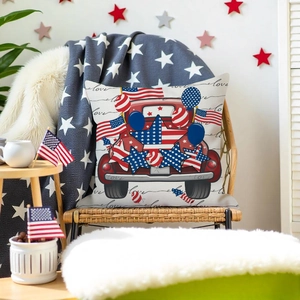 Close-up of patriotic USA flag pillow case with red truck on a rattan chair