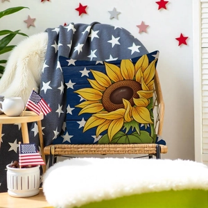Detailed texture of sunflower and star pattern pillowcase on a cozy rattan chair