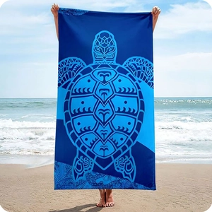 Detail of microfiber beach towel featuring a decorative sea turtle totem in deep blue hues