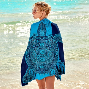 Microfiber beach towel featuring a large artistic turtle design on a sunny beach background