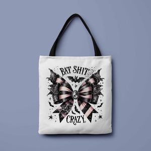 Detail of Bat Shit Crazy gothic print and striped bow on a white canvas tote bag