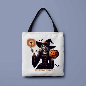 Close-up of the witch and pumpkin print on white canvas tote with Feeling Witchy text