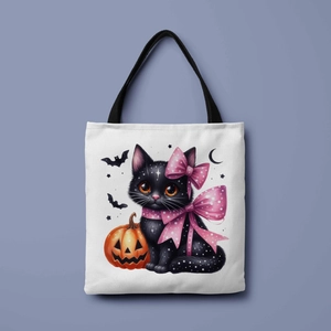 Detail of canvas tote bag featuring a cute black cat and orange Halloween pumpkin print
