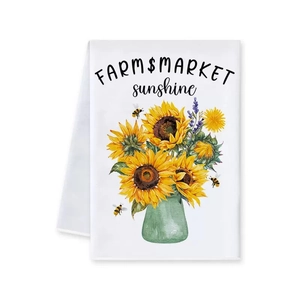 Detailed view of white fabric napkin featuring sunflower print and farm market text