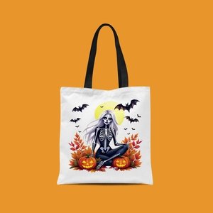 Detail of Halloween canvas tote featuring a skeleton girl, pumpkin, and bat graphics