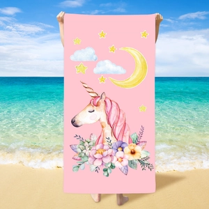Detail of soft microfiber beach towel with watercolor unicorn and floral print on pink fabric