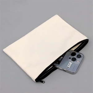 Detail view of cream canvas cosmetic bag with black zipper showing phone storage space