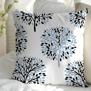 Detail shot of white square cushion cover with blue and black abstract tree patterns