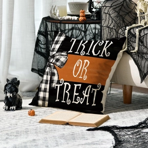 Halloween pillow cover with Trick or Treat text and plaid bow on black and orange fabric