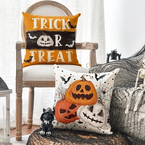 Halloween linen pillow covers with pumpkin and Trick or Treat prints on vintage wooden chair