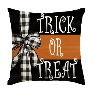 Detail of Trick or Treat Halloween pillow cover with orange-black blocks and plaid bow