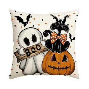 Detail of Halloween linen pillowcase featuring a cartoon ghost, black cat, and pumpkin motifs