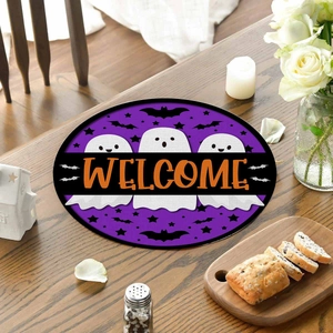 Detail of Halloween Welcome place mat with cute ghosts and bats on a dark wooden table