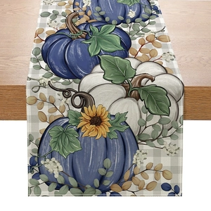 Detailed view of linen table runner with fall pumpkin sunflower patterns on a wooden table
