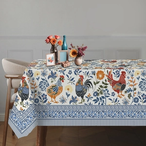 Detail of sunflower and rooster print on linen tablecloth with elegant vine border decor