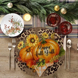 Round linen placemat with pumpkins and Happy Fall Y'all text on wooden table decor