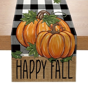 Detail of fall table runner featuring buffalo plaid, pumpkins and Happy Fall text