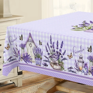 Detail of lavender floral print on purple plaid tablecloth over a wooden dining table