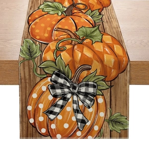 Close-up of autumn pumpkin table runner with buffalo check bow on wood background