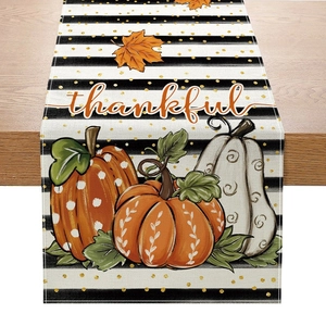 Macro view of thankful pumpkin table runner fabric texture and detailed maple leaf prints