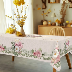 Detail of elegant rectangular tablecloth with floral rose border on wooden dining table