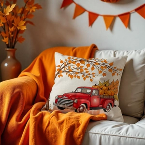 Macro detail of pumpkin truck cushion cover on sofa with cozy autumn fall decorations