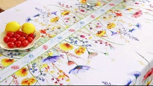 Close-up of sunflower and colorful floral print on rectangular tablecloth fabric