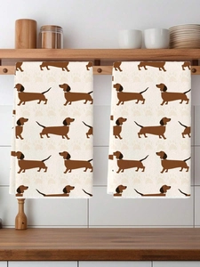 Detail of two kitchen towels with dachshund patterns hanging on a wooden rack