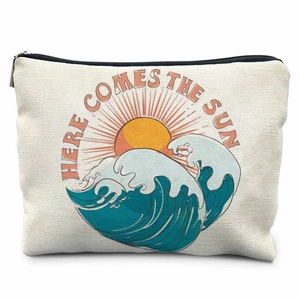 Detail of vintage canvas pouch featuring sunset wave print and Here Comes The Sun text