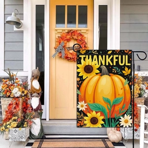 Close-up of Thankful garden flag with pumpkins and sunflowers in a porch setting