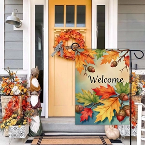 Close-up of fall garden flag with pumpkin and maple leaves decoration at house entrance