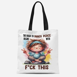 Detail of white canvas tote bag featuring funny quote print and black handles